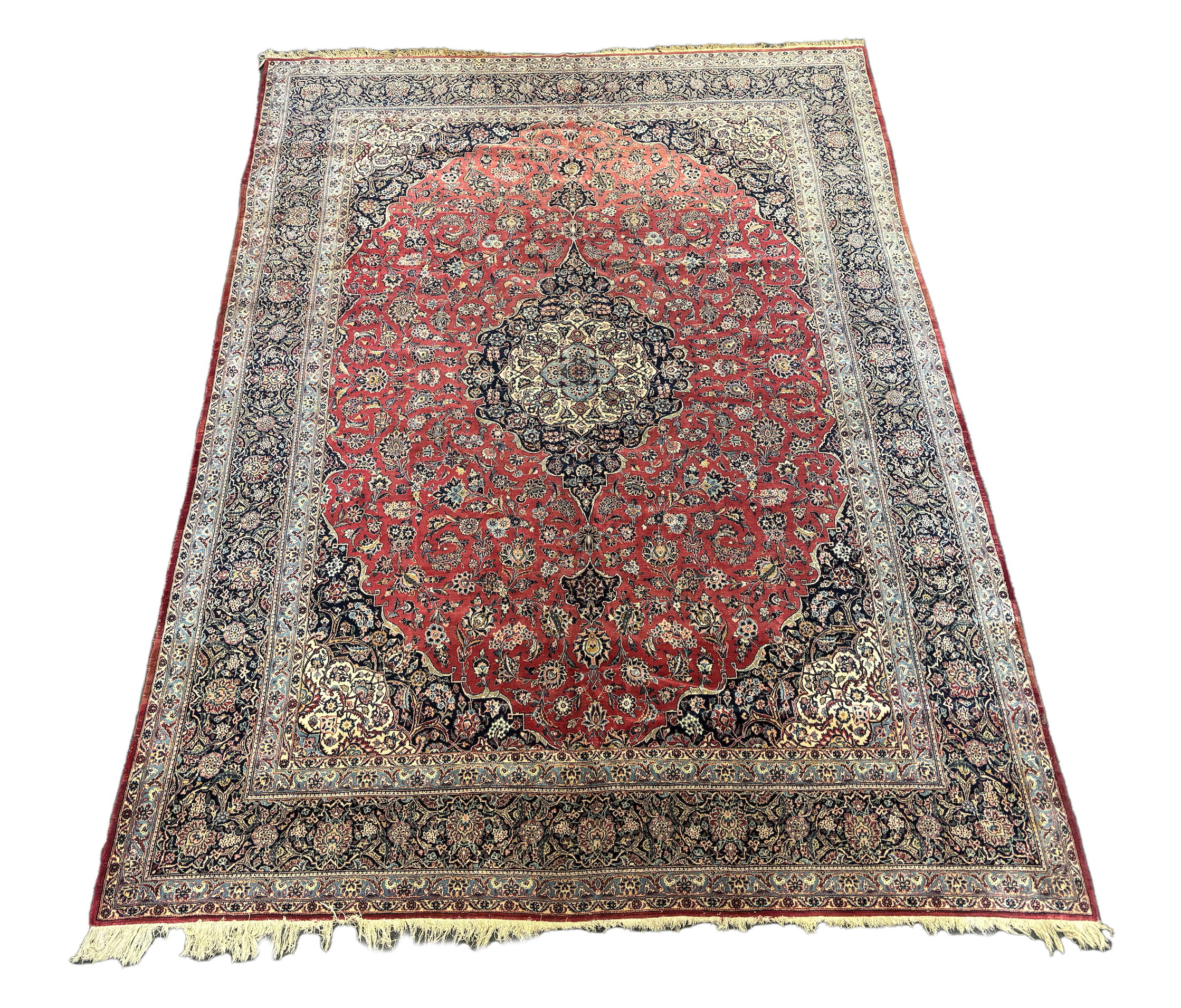 A Persian Kashan carpet with central medallion on a foliate red ground, multi bordered, 430 x 315cm